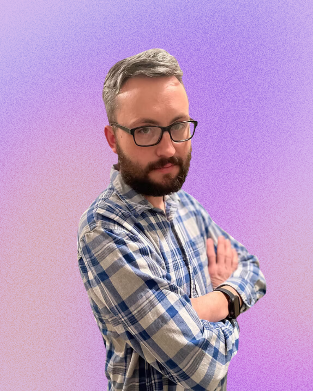 A man with a beard and glasses is standing with his arms crossed.