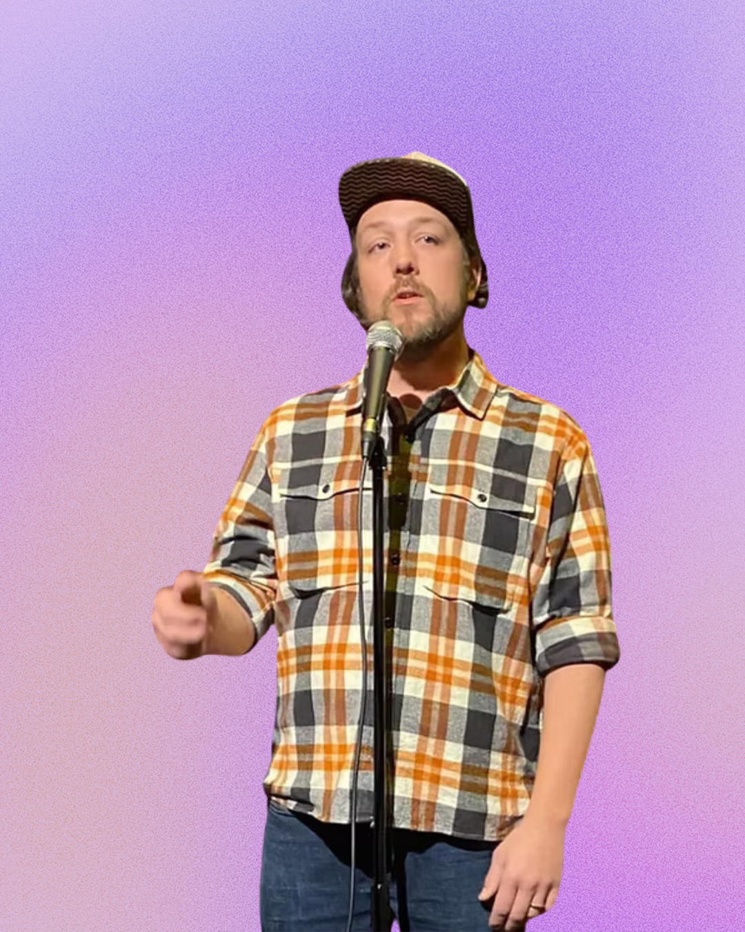 A man in a plaid shirt is singing into a microphone