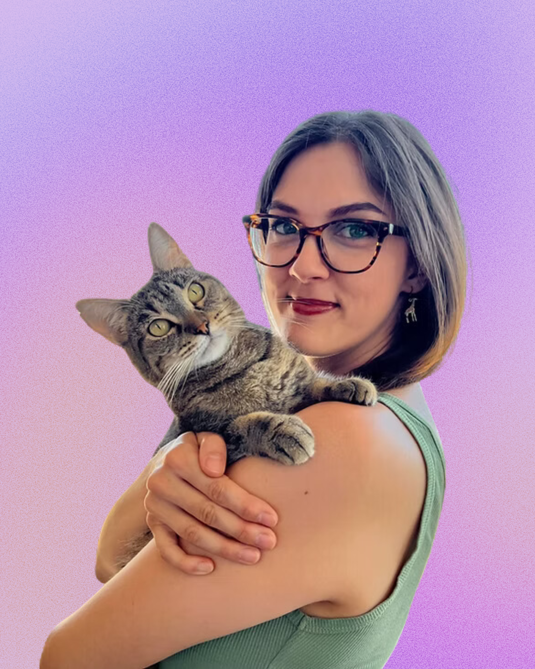 A woman wearing glasses is holding a cat on her shoulder