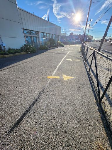 A yellow arrow is painted on the side of the road.