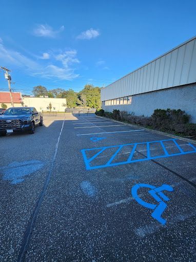 A handicapped parking spot is painted blue in a parking lot.