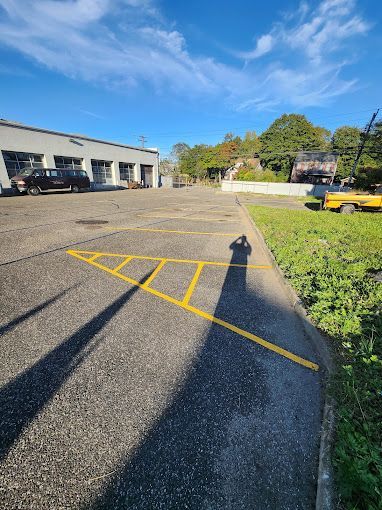 A parking lot with a yellow line on the side of it.