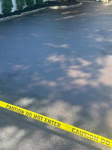 A parking lot with a yellow tape that says `` caution do not enter ''.