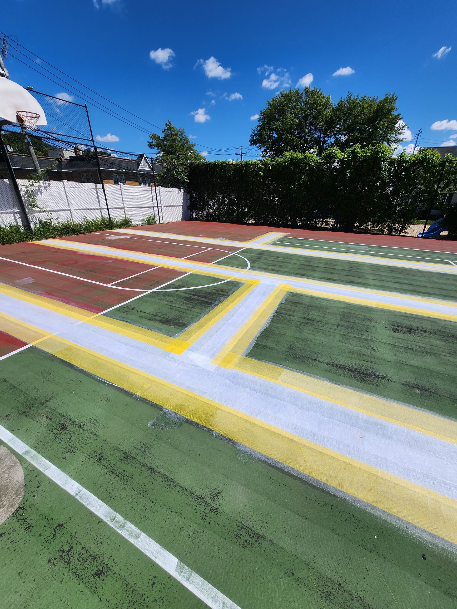 A basketball court with a basketball hoop in the background