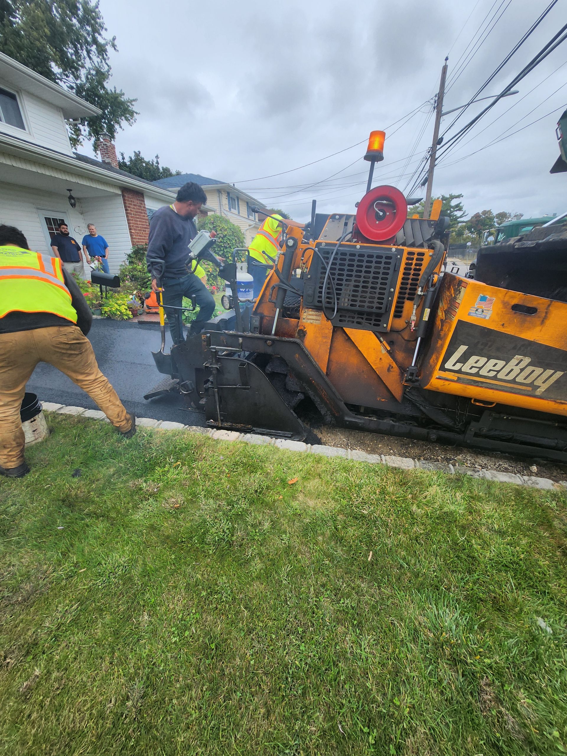 A group of construction workers are working on a road.