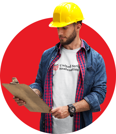 A man wearing a hard hat is holding a clipboard.