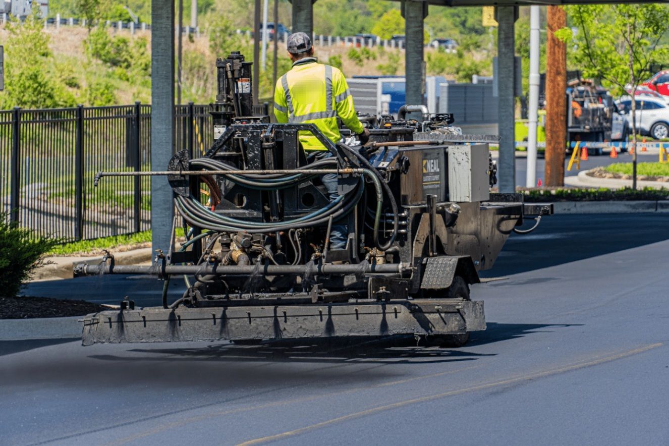 A group of construction workers are working on a road.