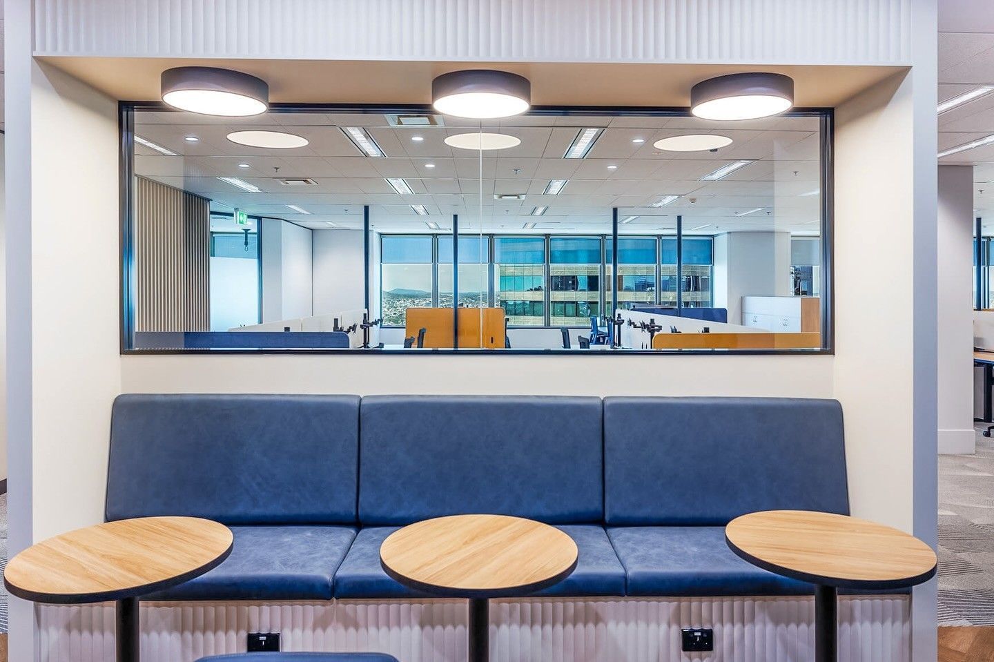A Modern Office Waiting Area With a Blue Sofa, Three Small Wooden Table — McCormick Upholstery In Coolum Beach, QLD