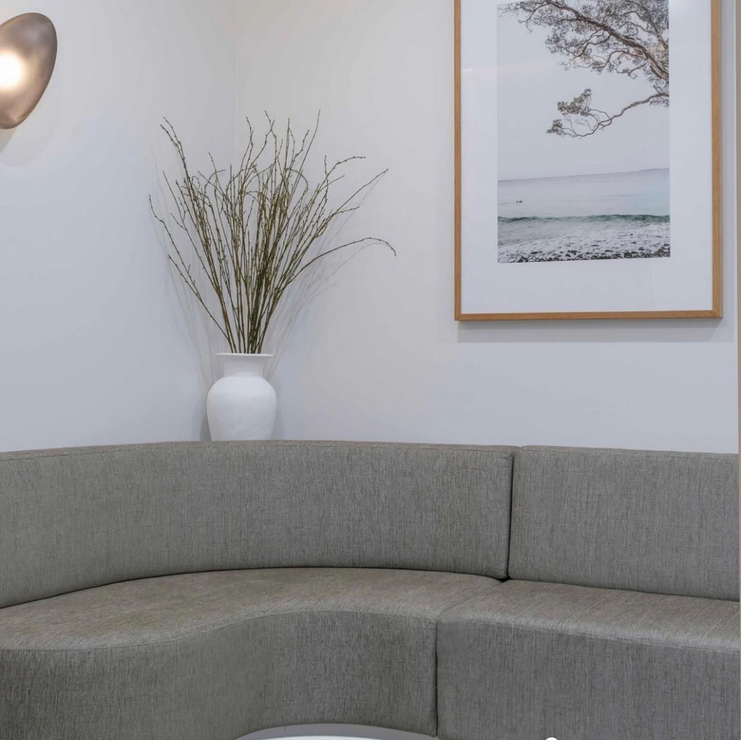 Gray Curved Sofa in a Room With White Walls — McCormick Upholstery In Coolum Beach, QLD