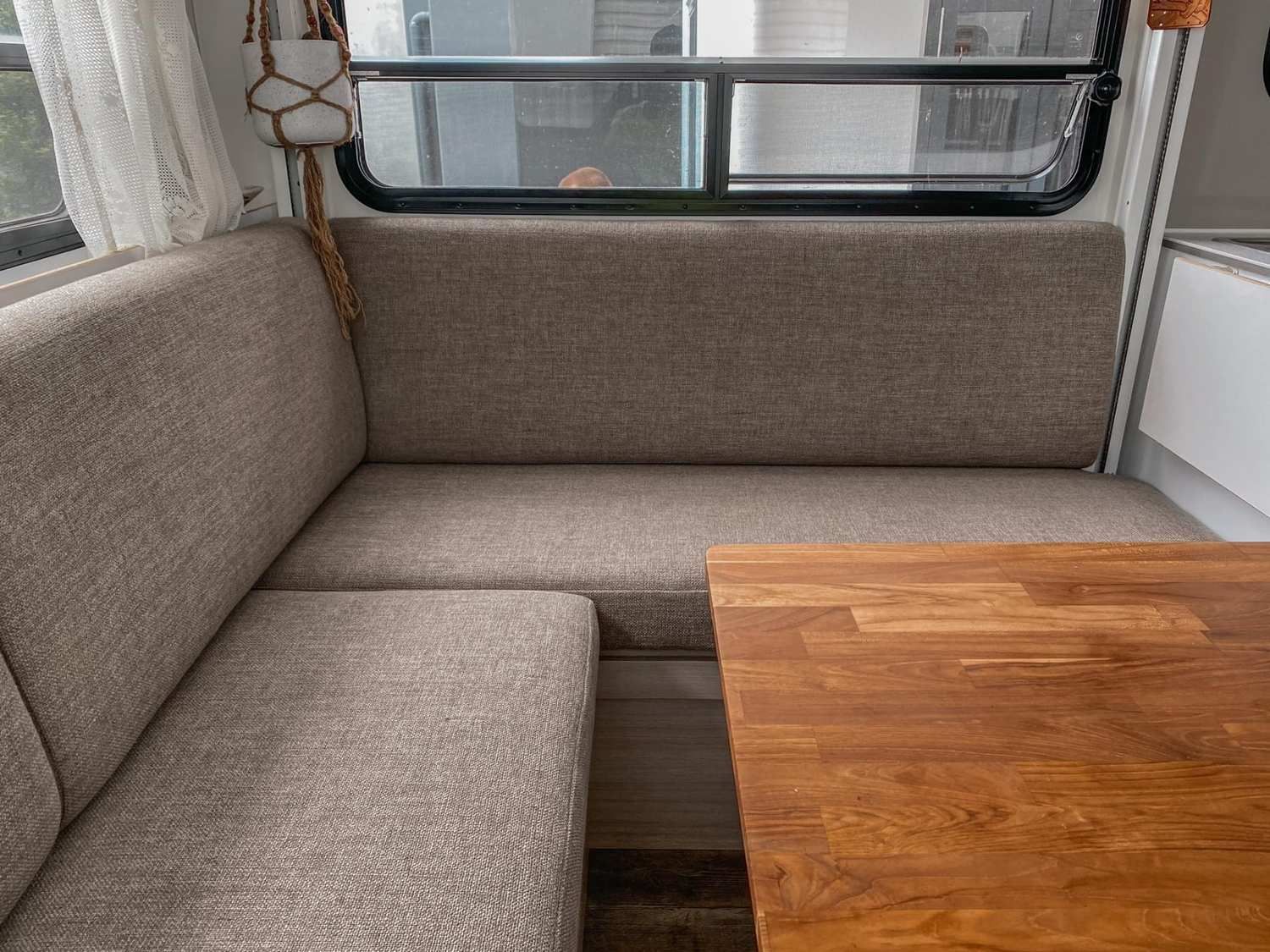 L-Shaped Booth Seating in a Camper Interior With a Wood Table and Window — McCormick Upholstery In Coolum Beach, QLD