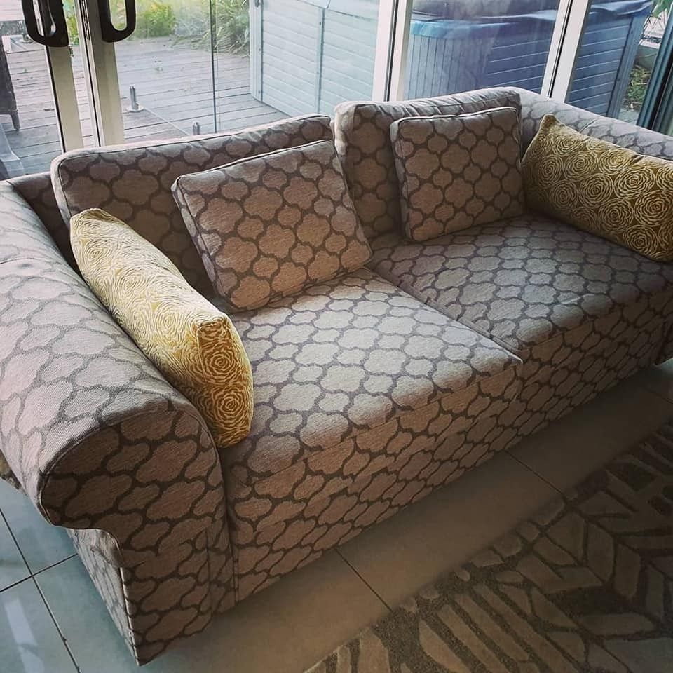 A Patterned Gray and White Sofa With Gold Accent Pillows — McCormick Upholstery In Coolum Beach, QLD