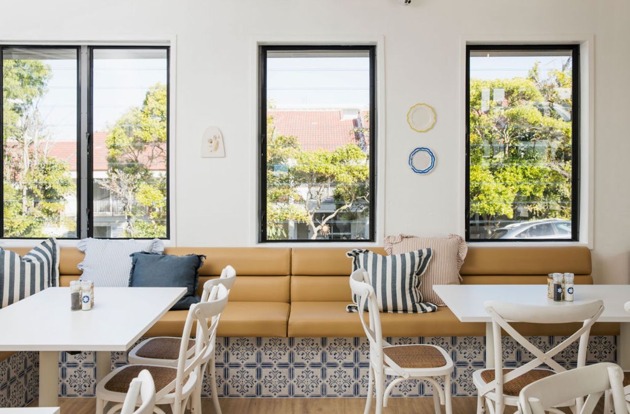 A Round Wooden Table Surrounded by Four Green Striped Armchairs — McCormick Upholstery In Coolum Beach, QLD