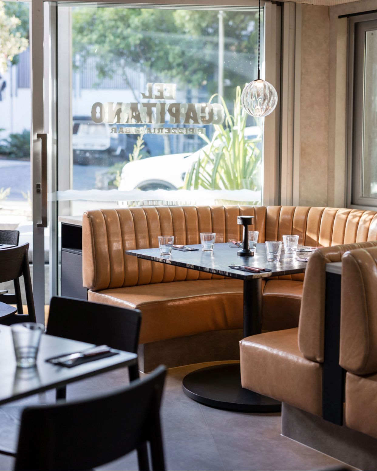 Outdoor Dining Area With Tables and Blue Chairs Overlooking the Ocean — McCormick Upholstery In Coolum Beach, QLD