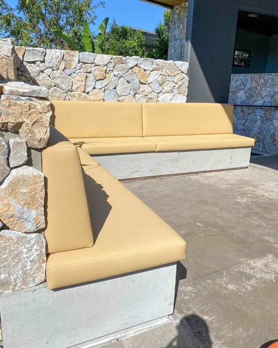An Outdoor Concrete Bench With Tan Cushions — McCormick Upholstery In Coolum Beach, QLD