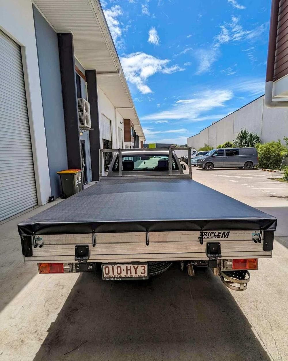 Rear View of a White Utility Truck With a Black Cover — McCormick Upholstery In Coolum Beach, QLD