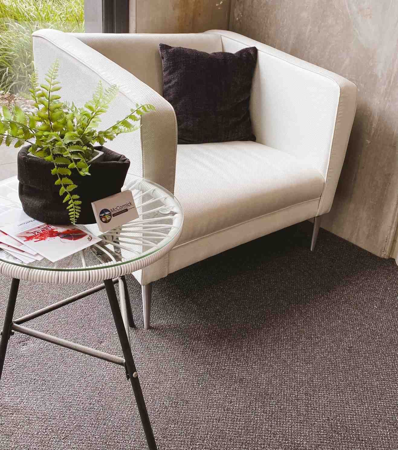A Modern White Armchair With a Black Pillow — McCormick Upholstery In Coolum Beach, QLD