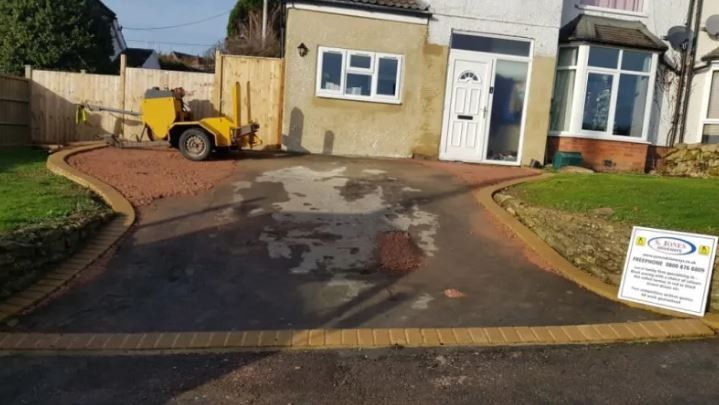 Garage Driveway with yellow truck working