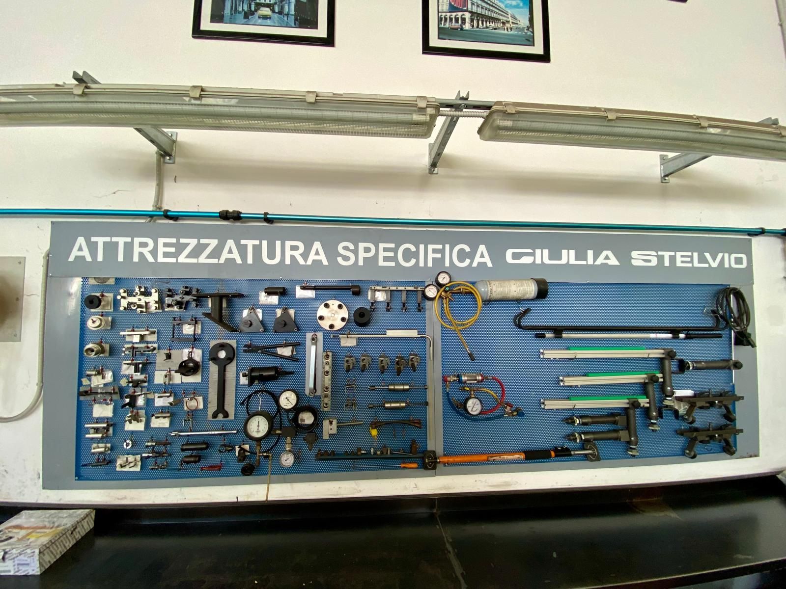 A wall with a sign that says attrezzatura specifica giulia stelvio