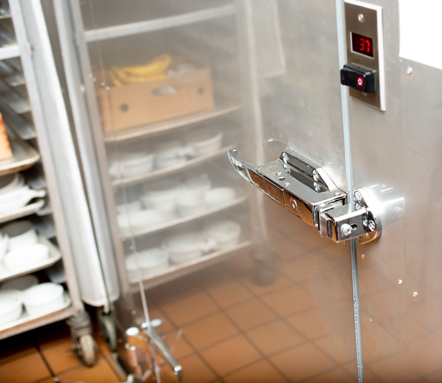 Commercial kitchen holding cabinet door with temperature display.