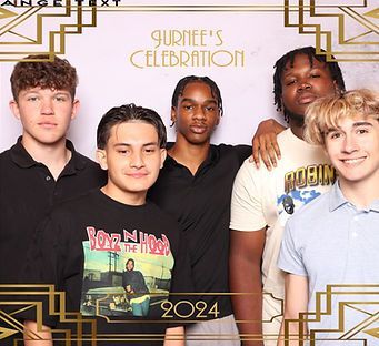 Five young men smiling, posing for photo, in front of a gold deco frame; 