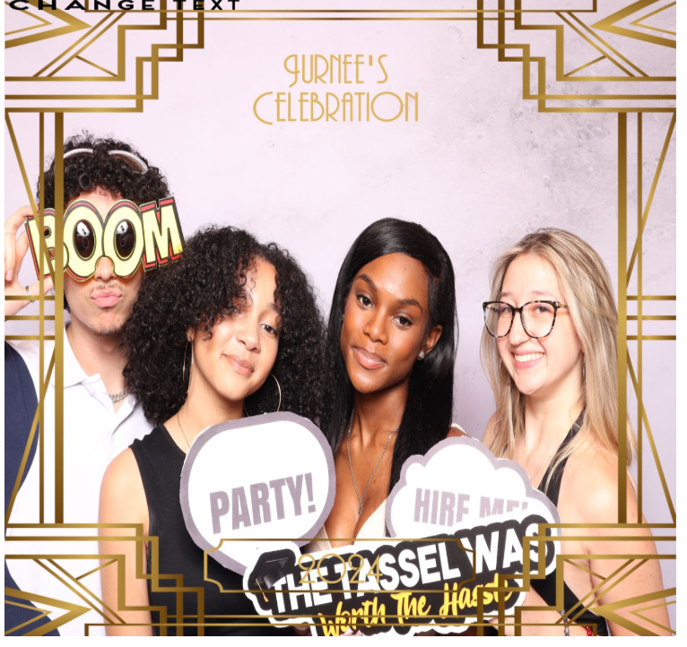 Four people posing in a photo booth. Two hold speech bubbles. Deco-style frame.
