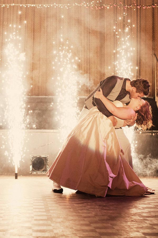 couple dancing infront of indoor fireworks