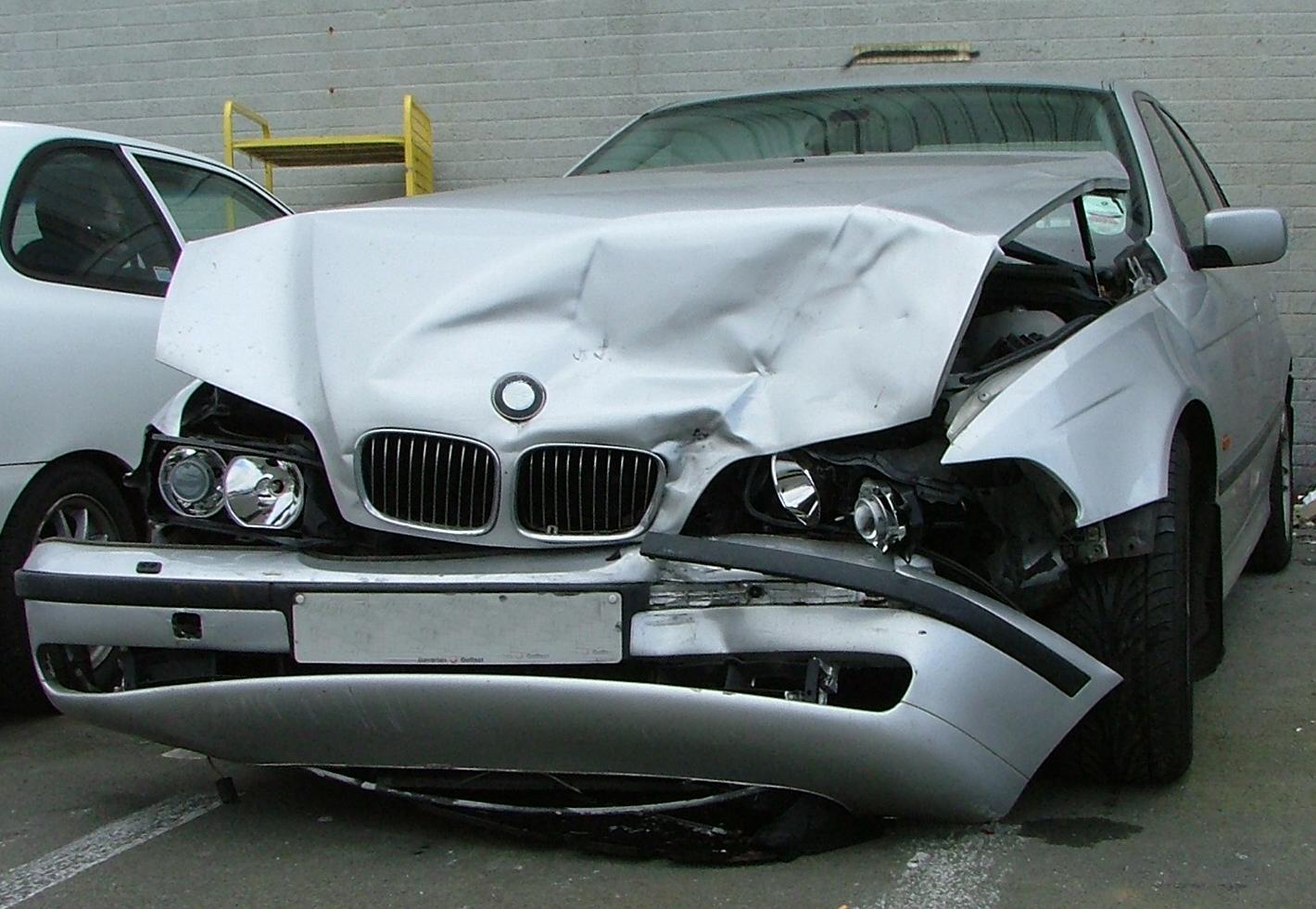 A silver bmw has been damaged in a car accident