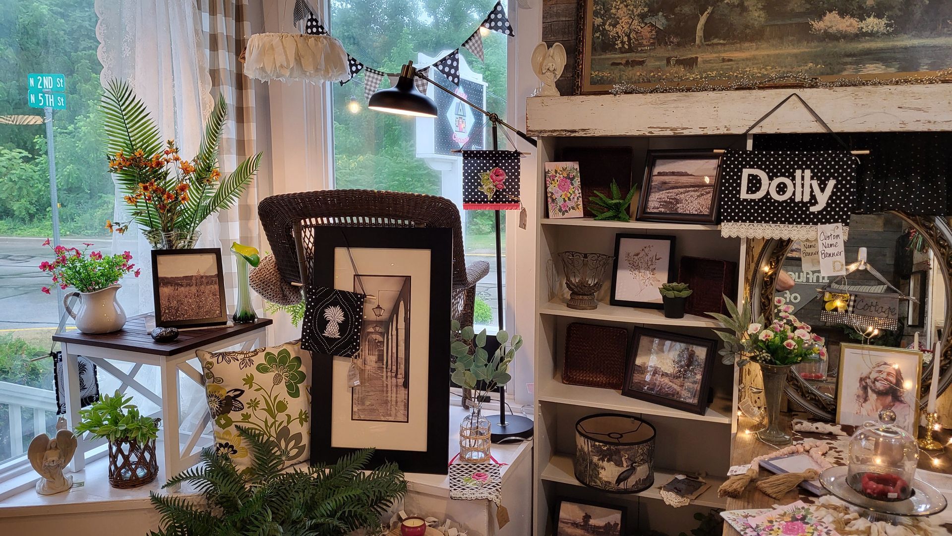 A living room with a couch , table , candles and a picture on the wall.