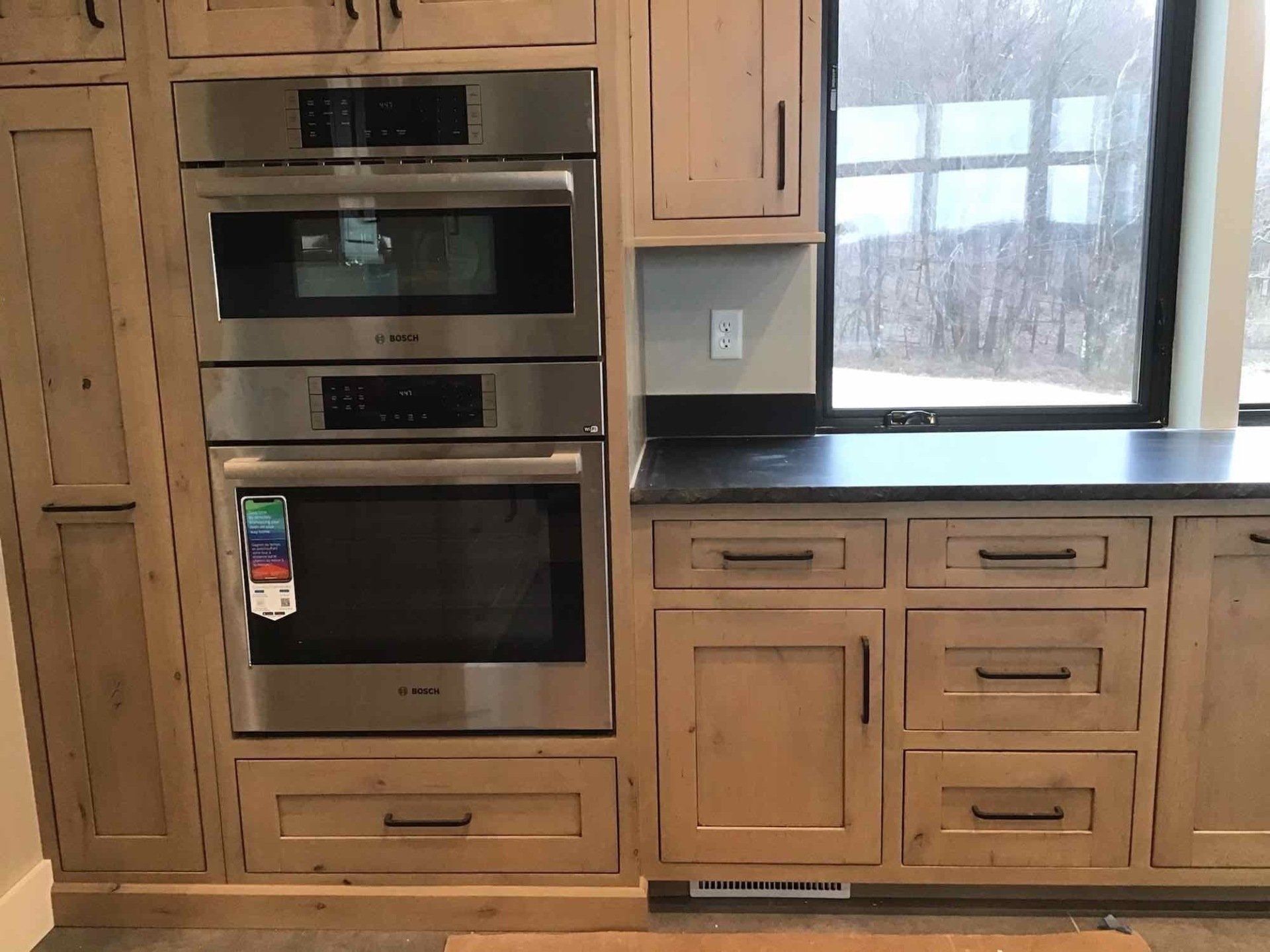 A kitchen with stainless steel appliances and wooden cabinets