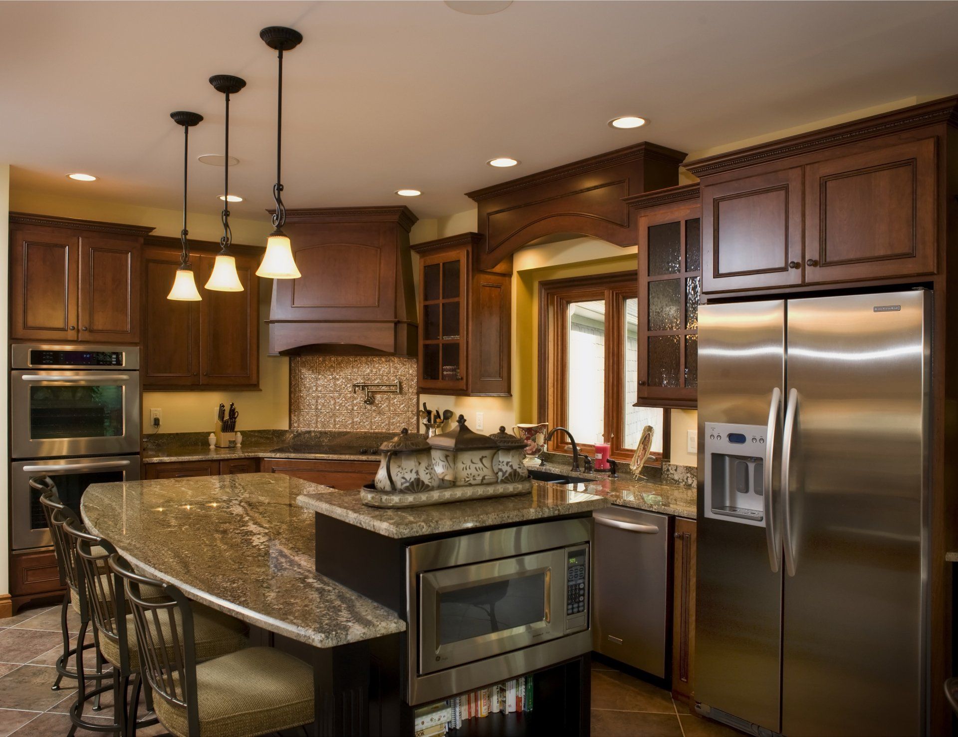 A kitchen with stainless steel appliances and granite counter tops.