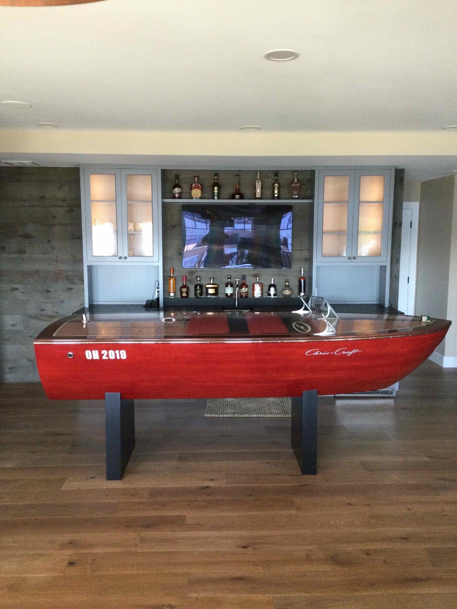 A pool table in the shape of a red boat