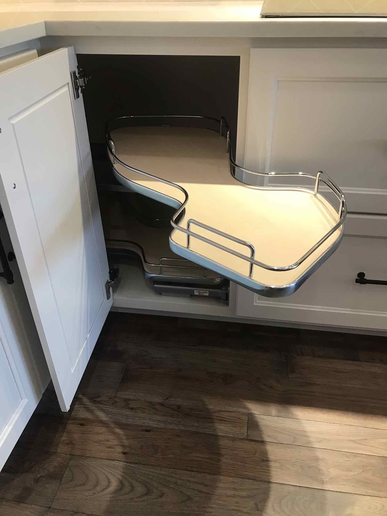 A kitchen cabinet with a custom pull out shelf in it.