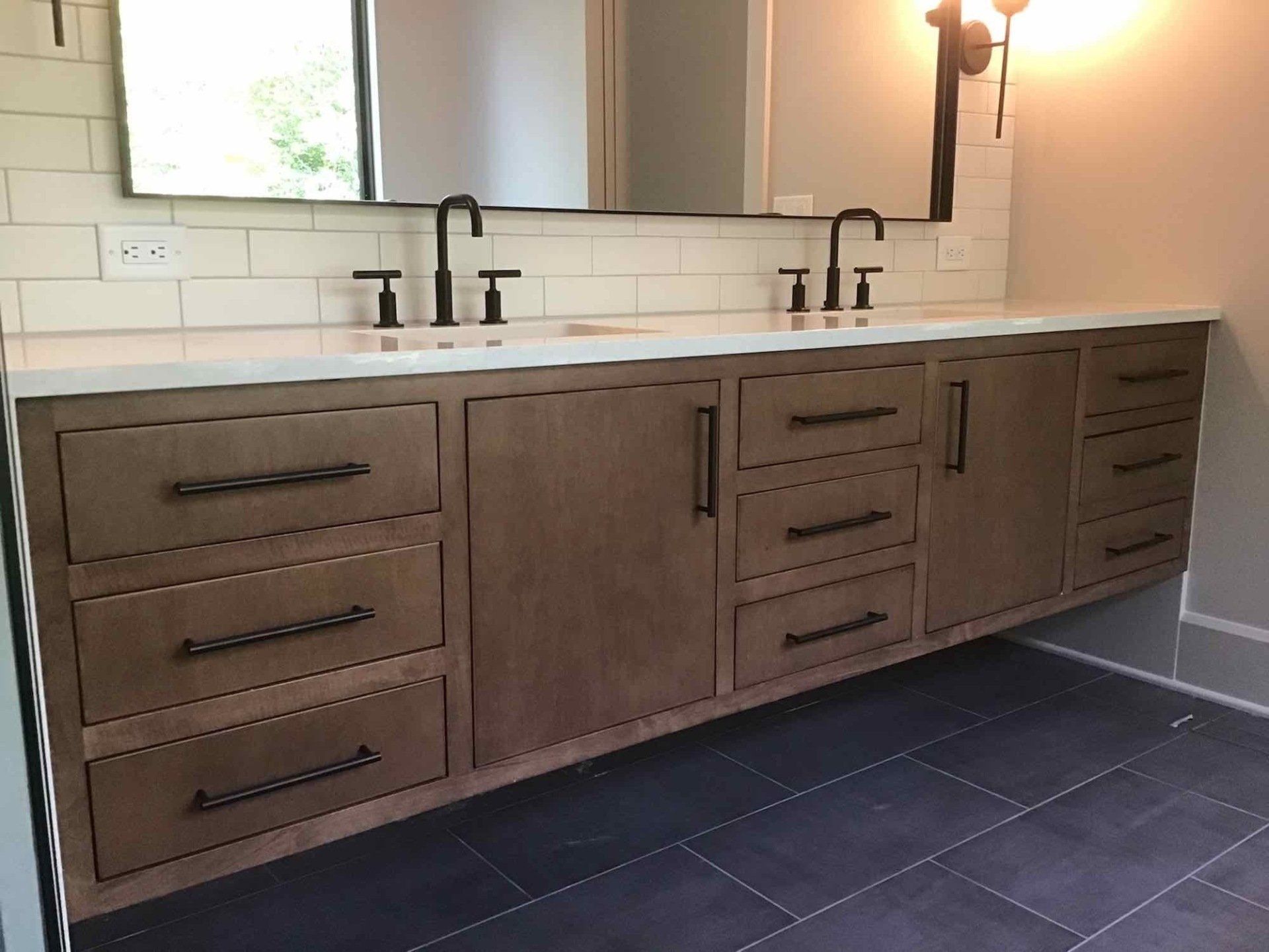 A bathroom with two sinks and a mirror.