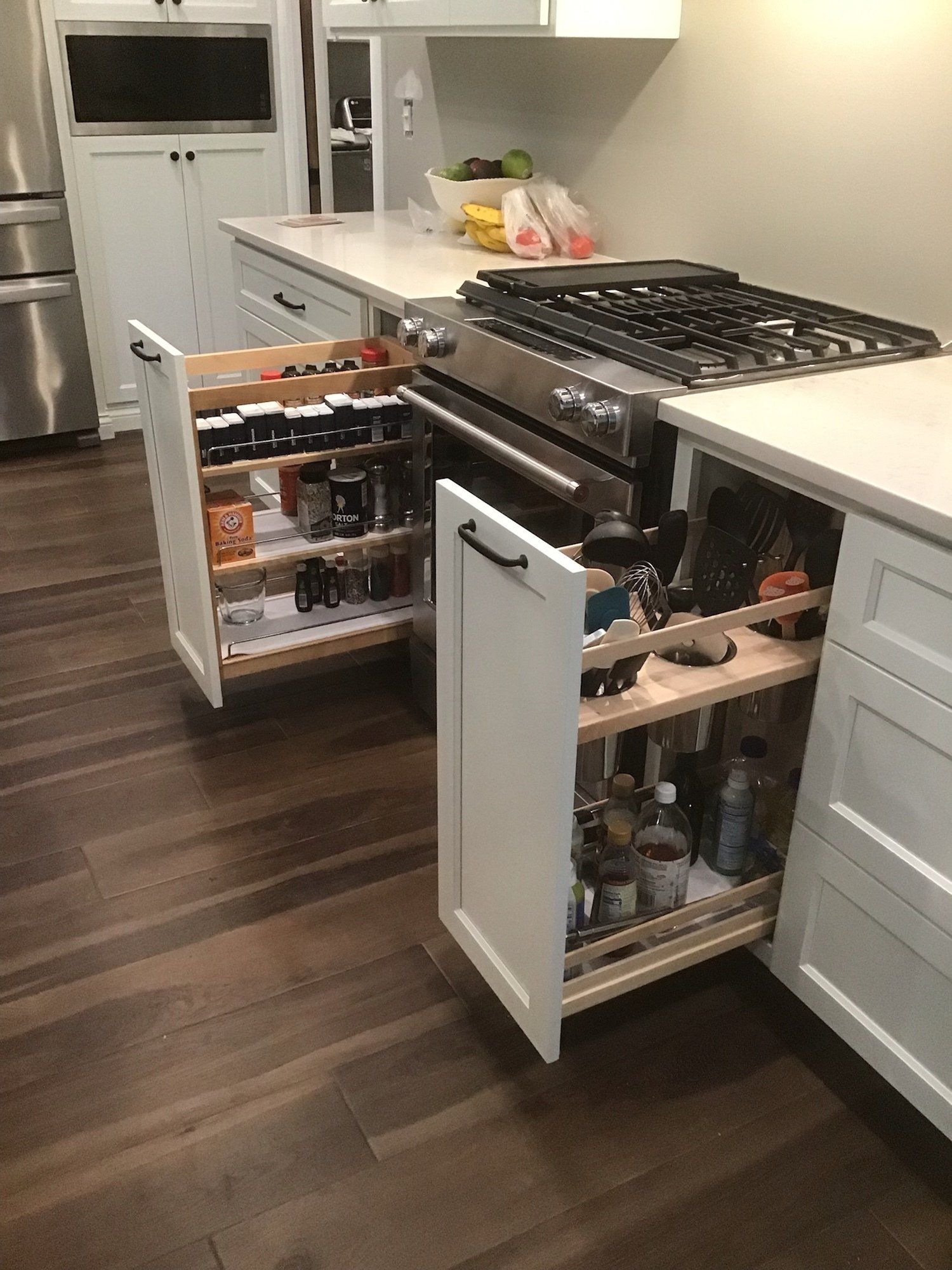 A kitchen with a stove and a bunch of drawers open.