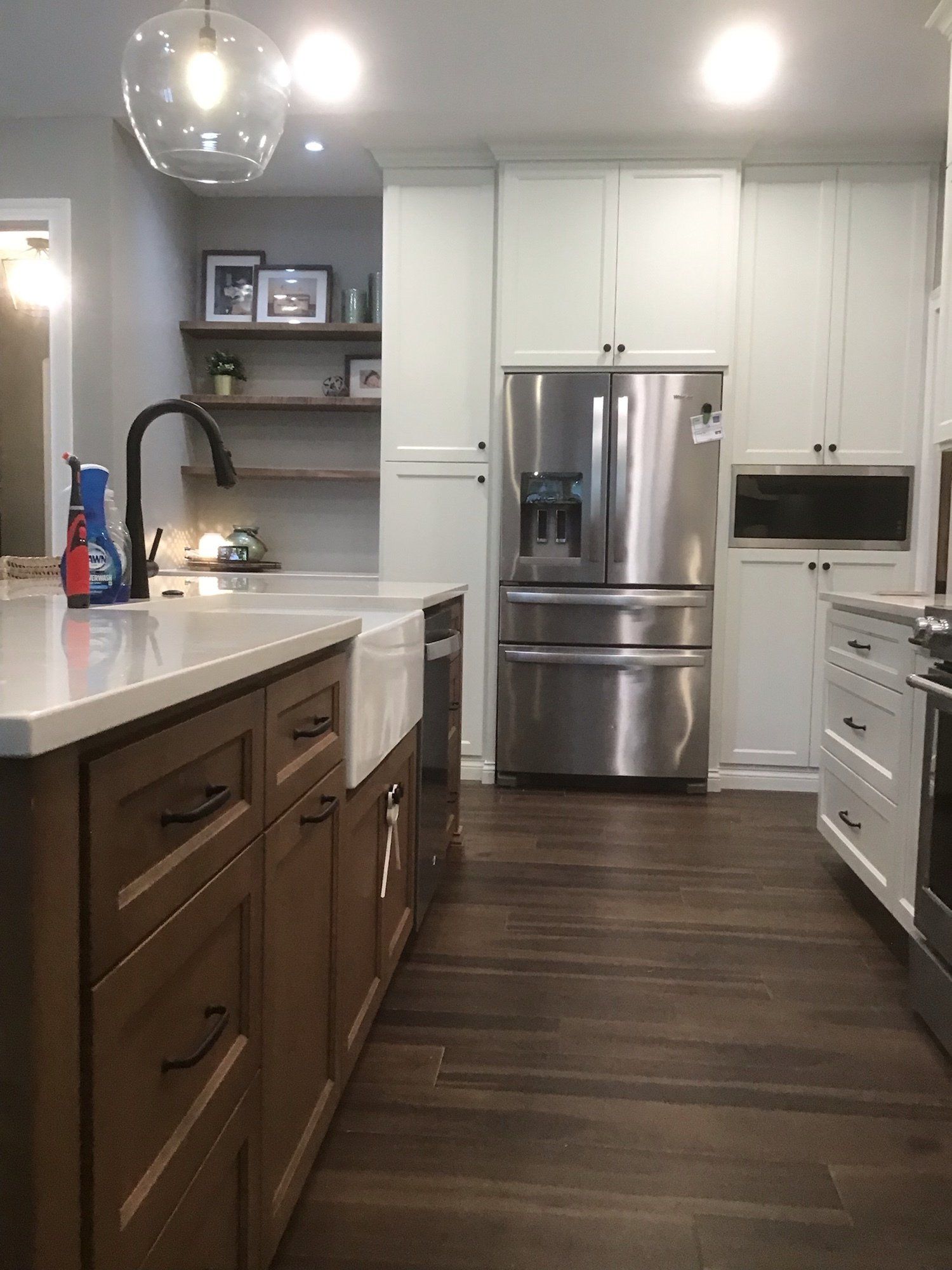 A kitchen with stainless steel appliances and wooden cabinets.