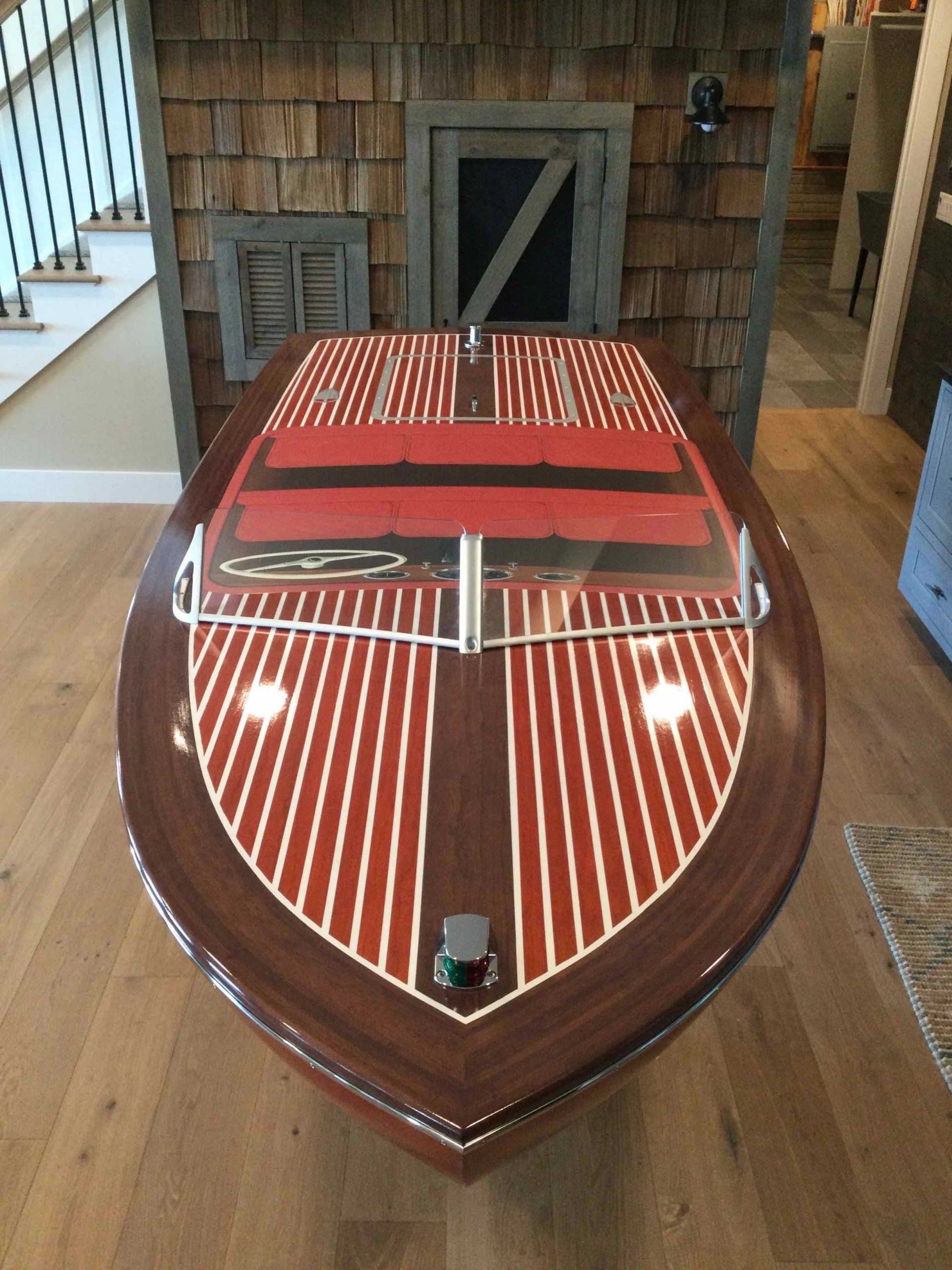 A wooden boat with a red and white striped deck