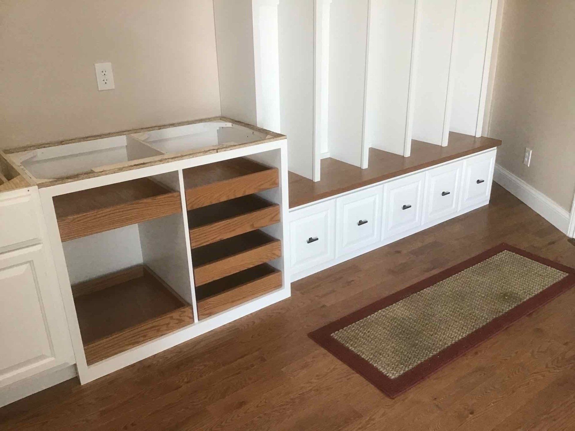 A  kitchen featuring cabinets, drawers, and shelving.