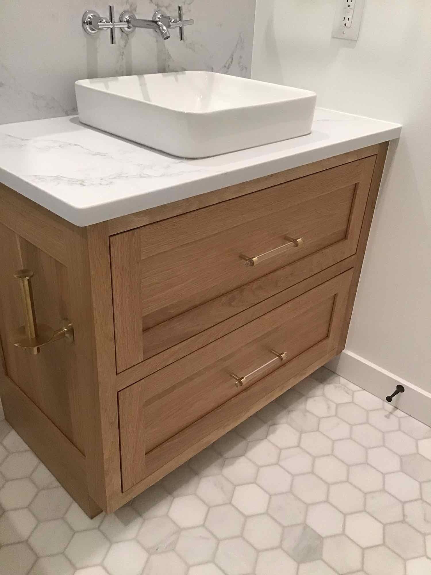 A bathroom vanity with a sink on top of it.