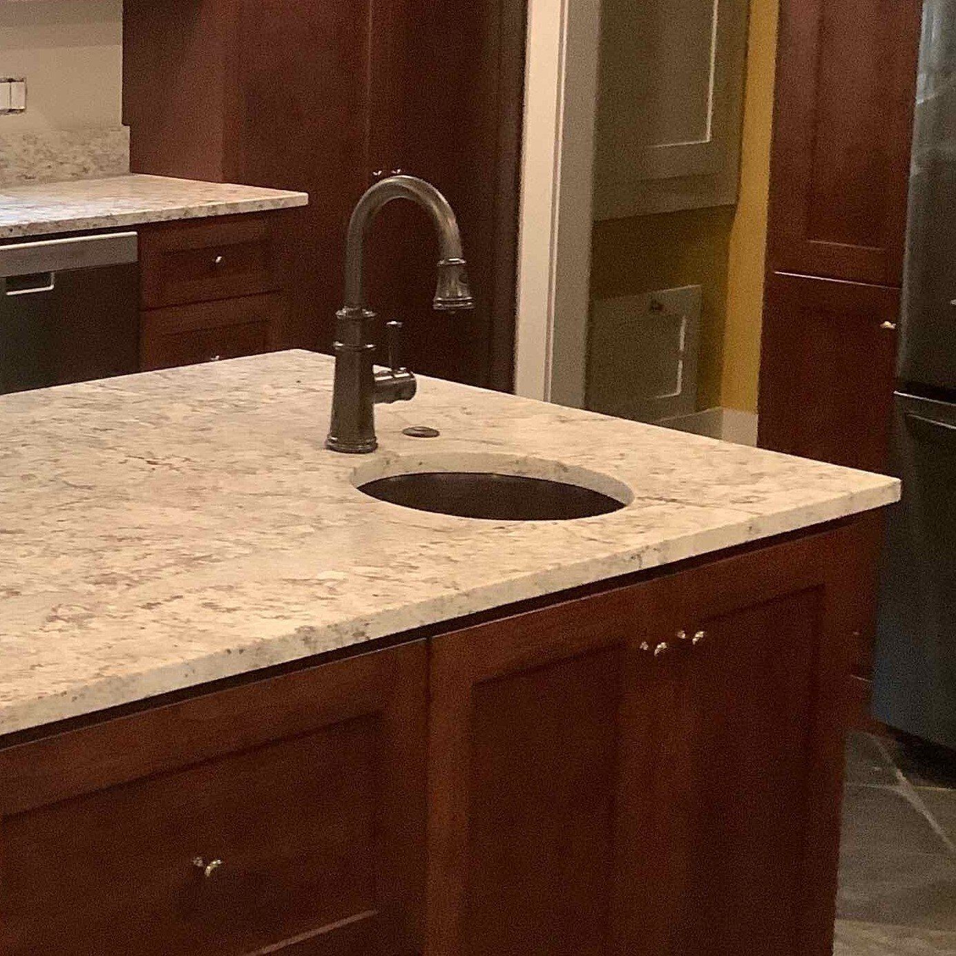 A kitchen counter with a sink and a faucet