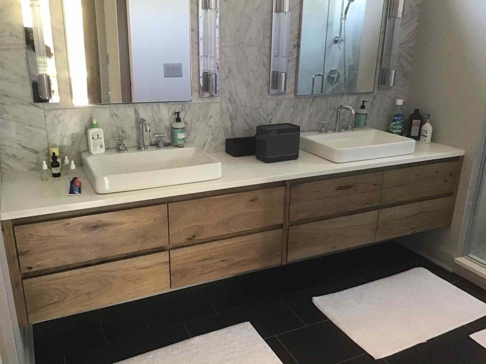A bathroom with two sinks and two mirrors.