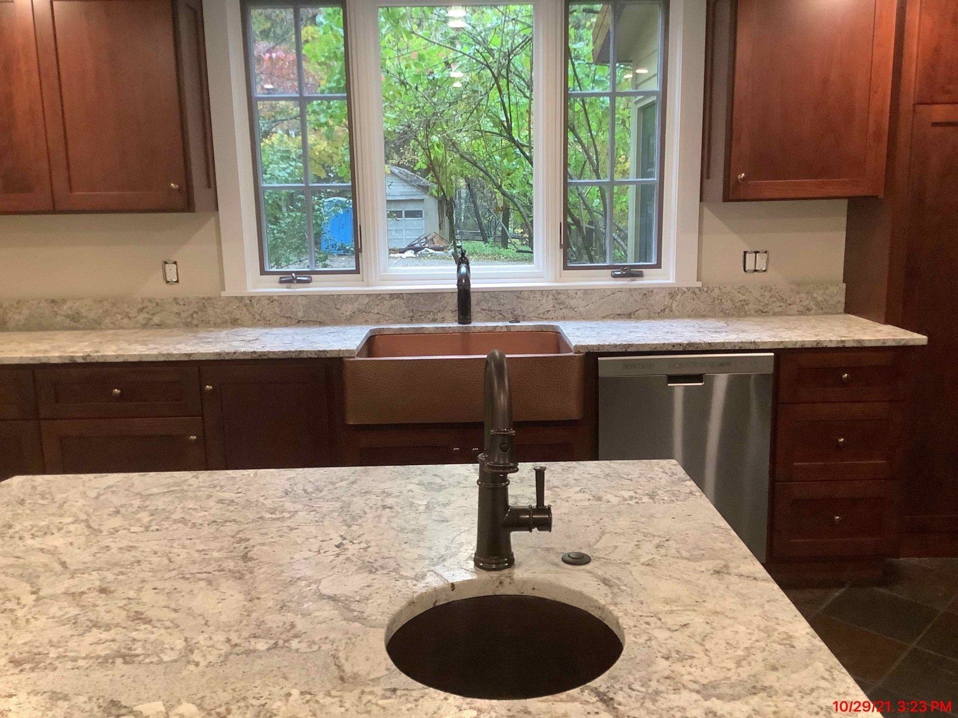A kitchen counter with a sink and a window