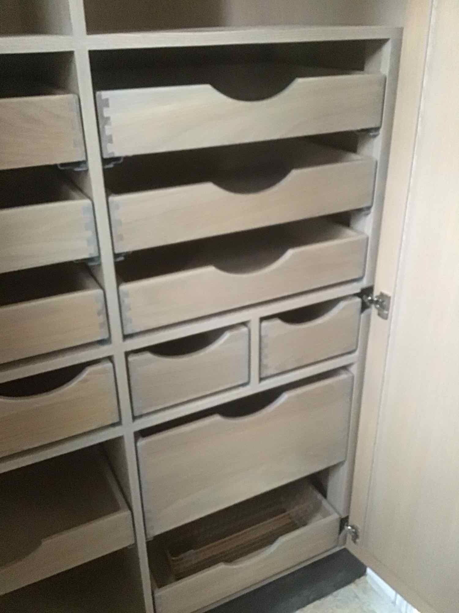 A closet with lots of drawers.