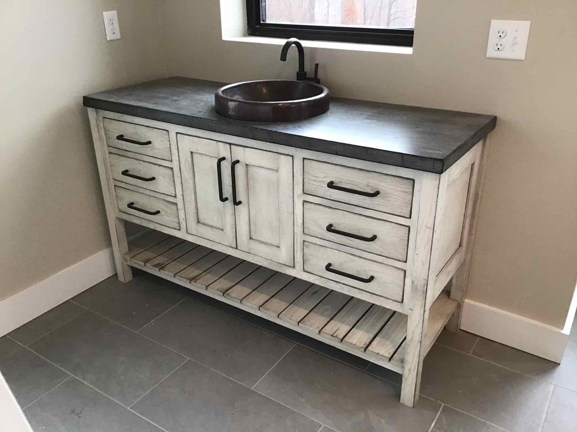 A bathroom vanity with a sink on top of it.