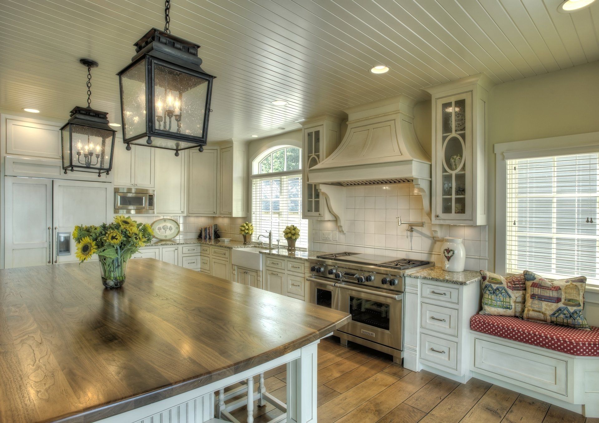 A kitchen with white cabinets and stainless steel appliances.