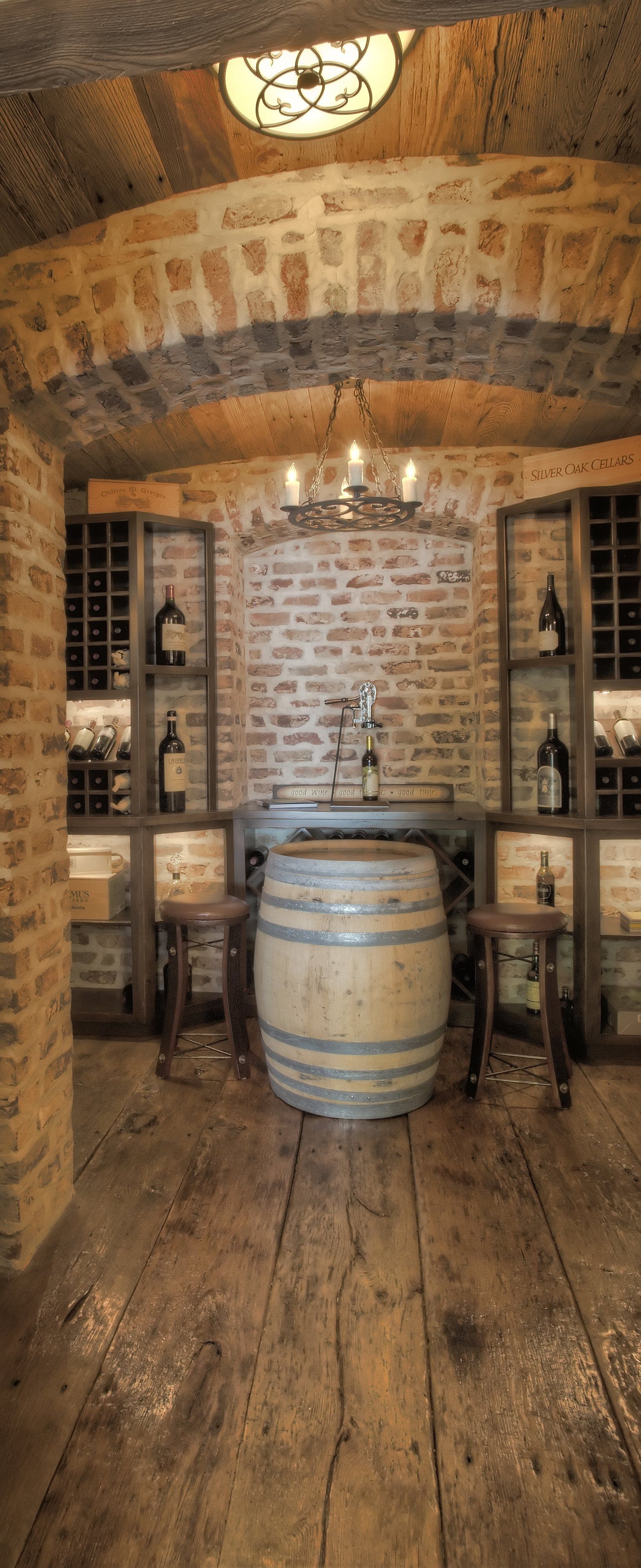 There is a barrel in the middle of the room in a wine cellar.