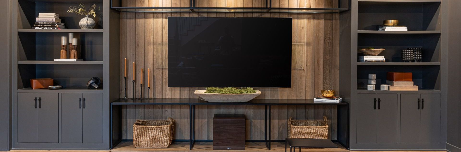 A living room with a large flat screen tv mounted on the wall.