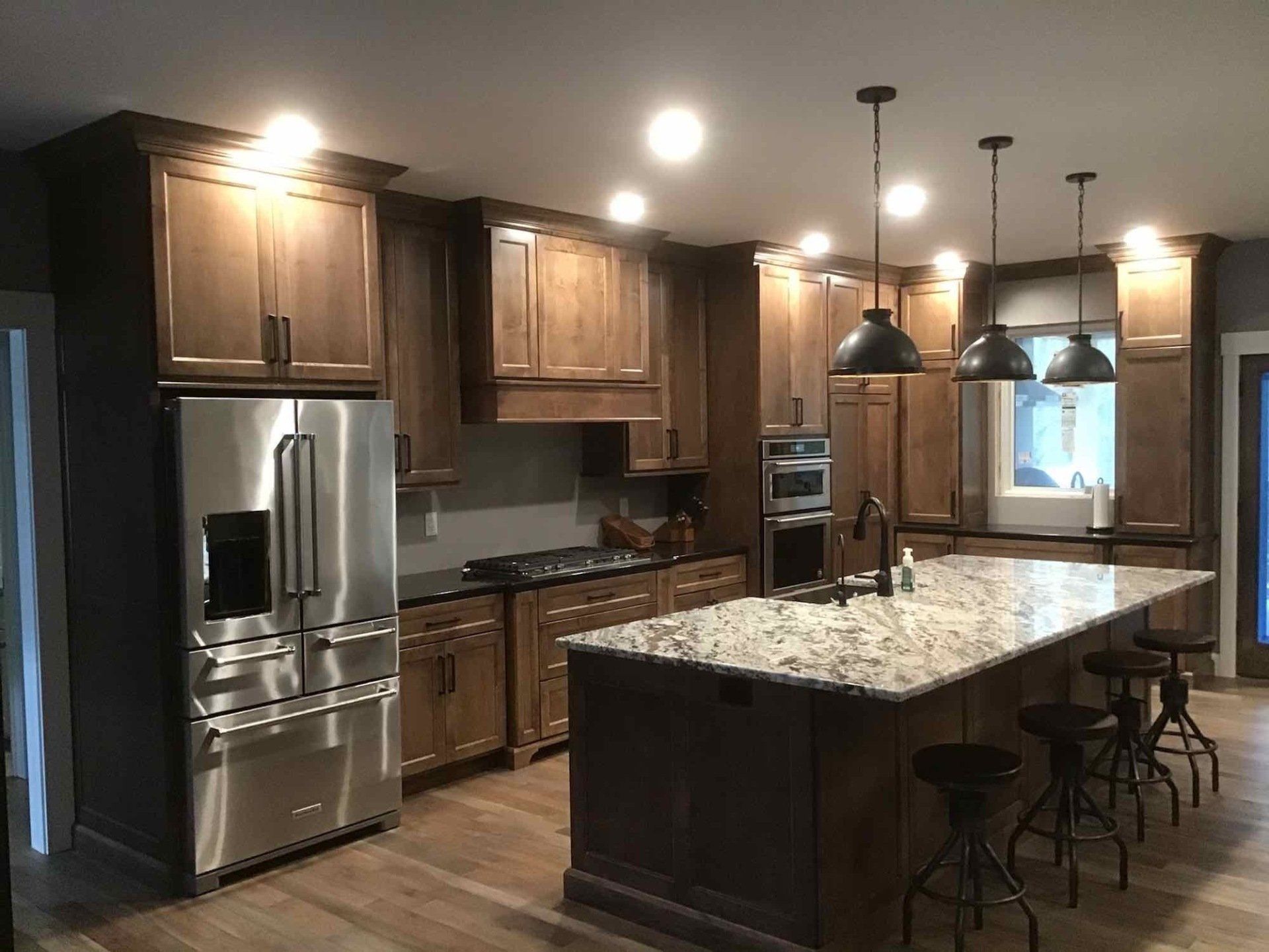 A kitchen with stainless steel appliances and wooden cabinets