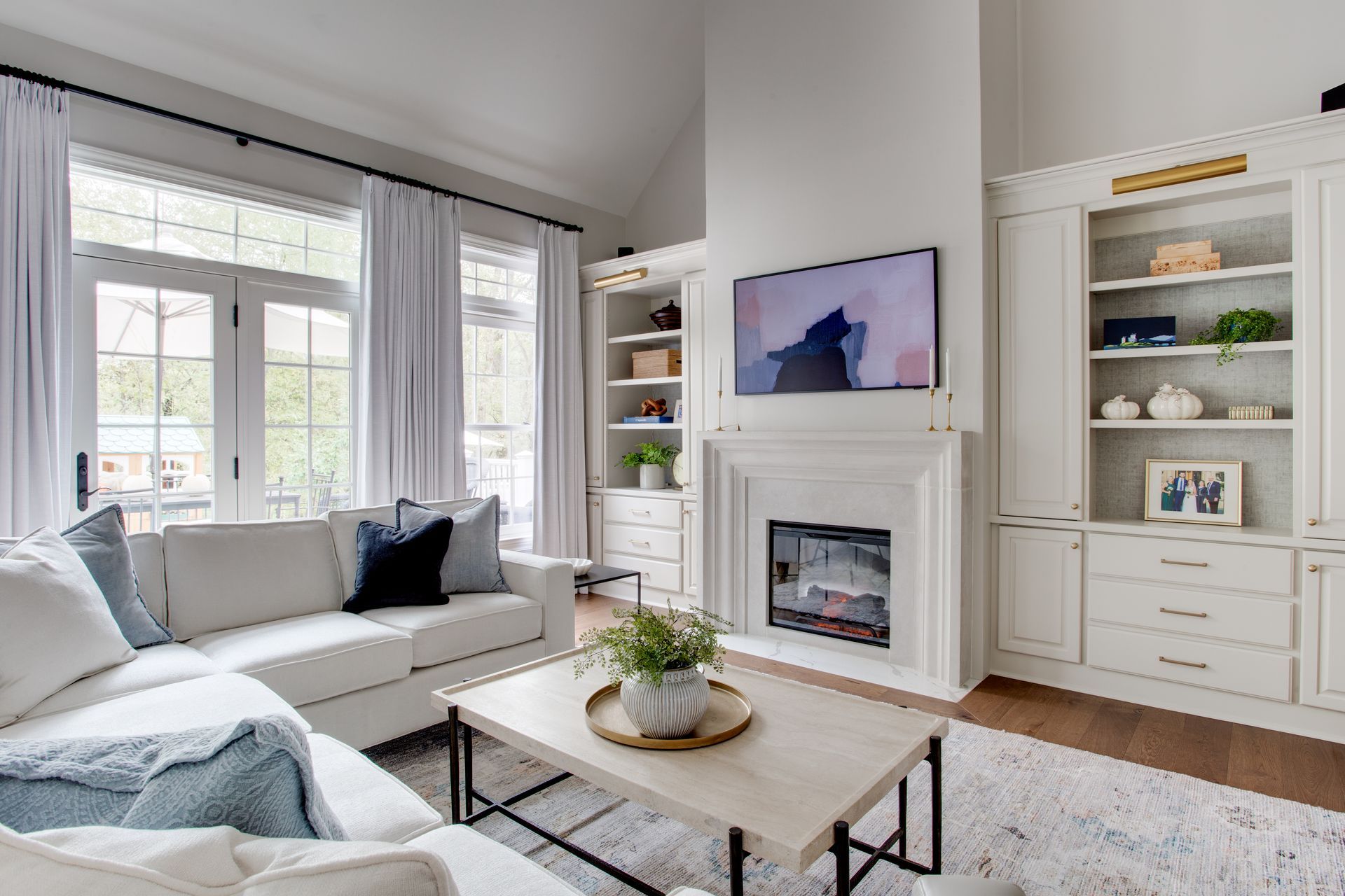 A living room with a fireplace , couch , coffee table and television.
