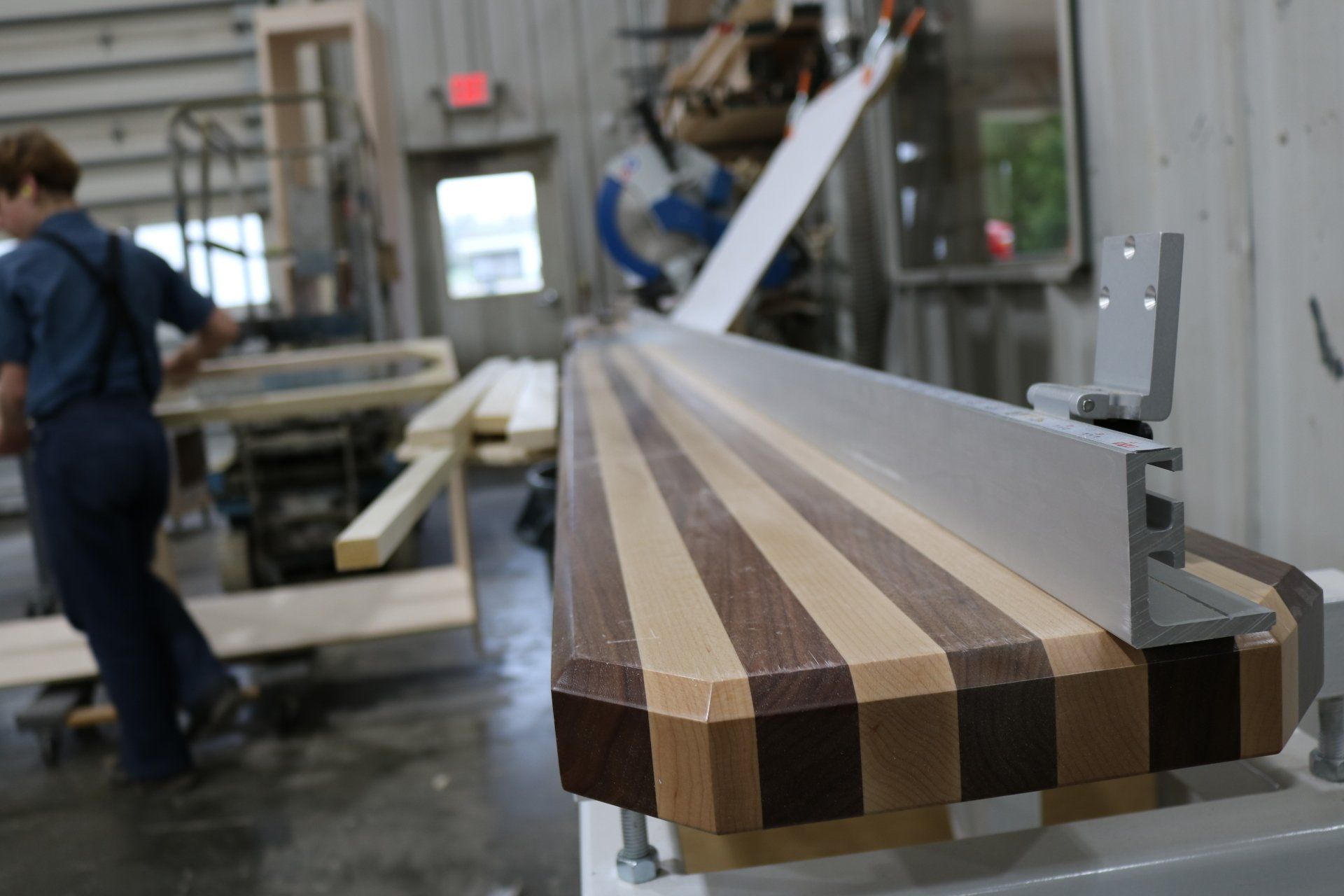 A man is working on a piece of wood in a factory.