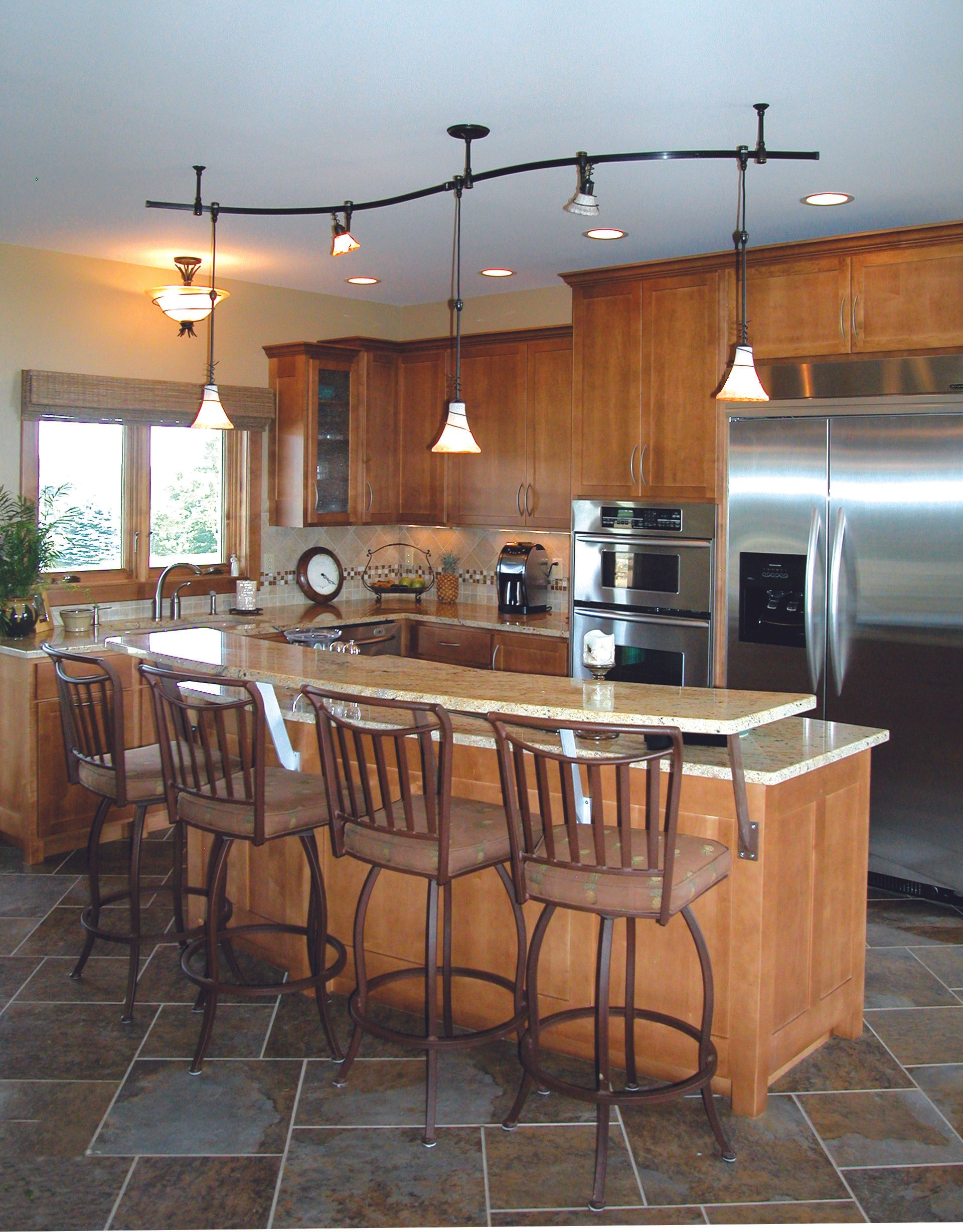 A kitchen with stainless steel appliances and wooden cabinets.